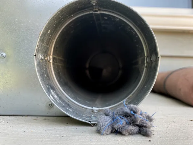 Laguna Hills Dryer Vent Cleaning technician using specialized equipment to clear severe dryer vent blockage in Laguna Hills